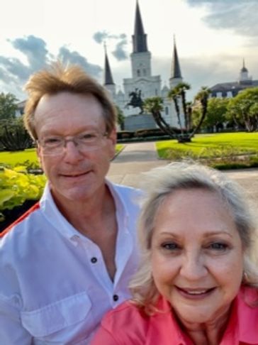 Couple posing for a selfie in front of a cathedral.
