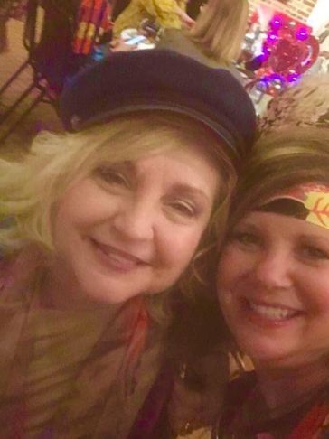 Two women smiling and taking a selfie.