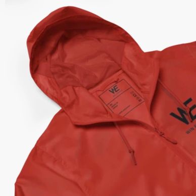 Red hooded jacket with a zipper and printed label inside the hood.