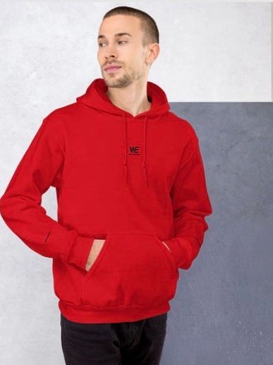 Man wearing a red hoodie with hands in pockets looking sideways.