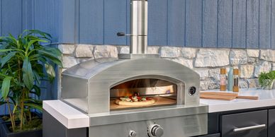 Outdoor pizza oven cooking a pizza