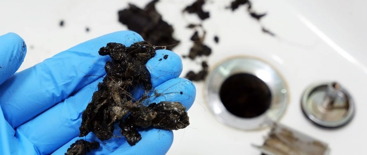 Hair and soap scum removed from basin drain