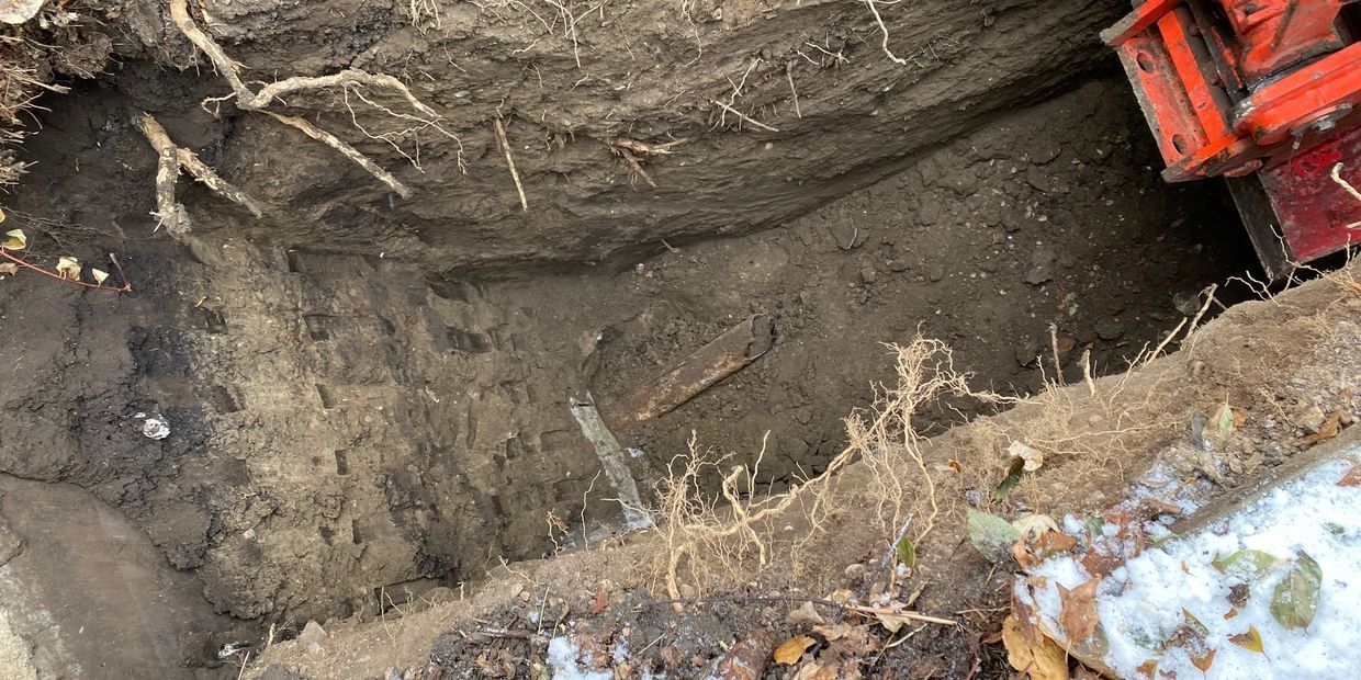 Exposed broken sewer line in rural airdrie property before repair