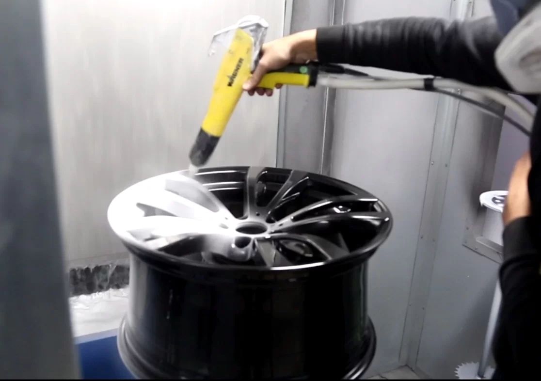 Powder coating being applied to a wheel at Skull Island Kustoms