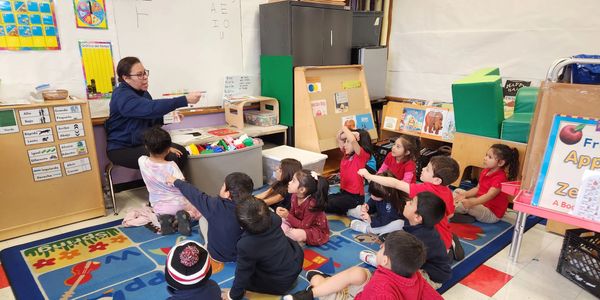 Students and teachers interacting in a safe classroom environment.