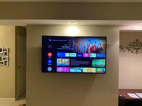 TV installed on to the drywall with a recessed outlet behind the TV. 