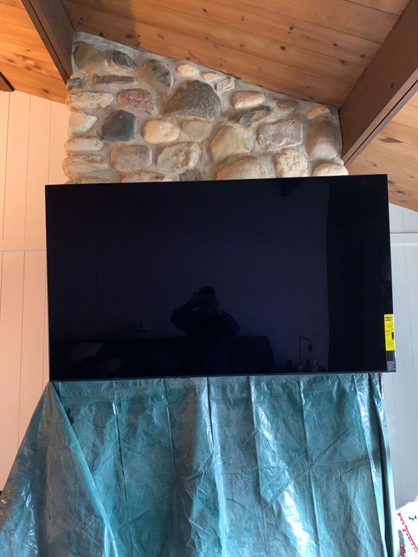 TV installed above the fireplace on an uneven surface.