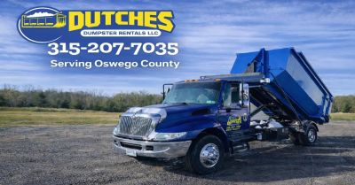 Blue dumpster rental truck from Dutches Dumpster Rentals LLC.