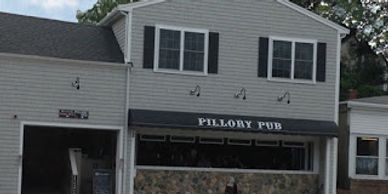 Exterior of Pillory Pub with awning and windows.