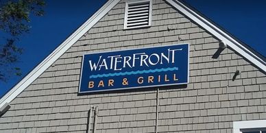 Sign for Waterfront Bar &amp; Grill on building.