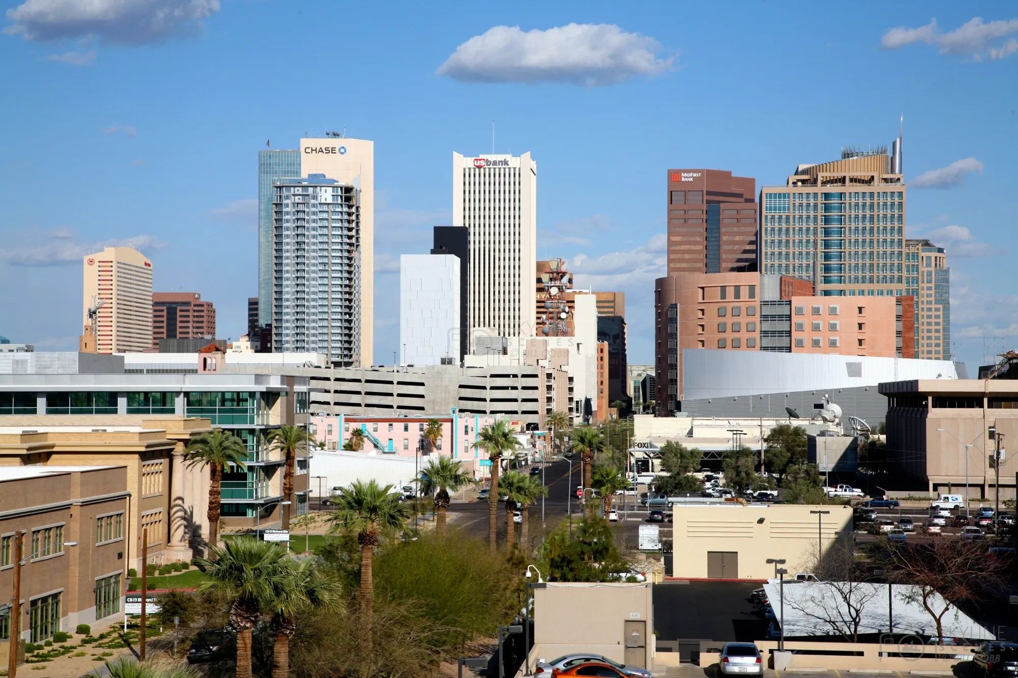 City skyline with various bank buildings under a clear blue sky.