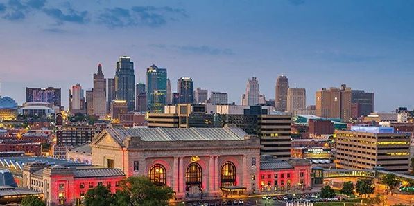 Kansas City skyline at dusk with Union Station in the foreground.