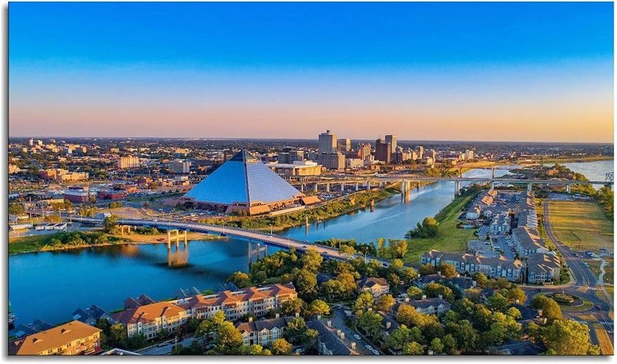 A vibrant cityscape with a pyramid-shaped building by a river during sunset.