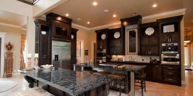 Luxurious kitchen with dark wood cabinets and granite countertops.