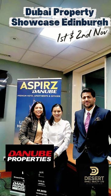 Three people at the Dubai Property Showcase in Edinburgh.