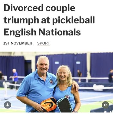 Divorced couple smiling with pickleball paddles after winning English Nationals.
