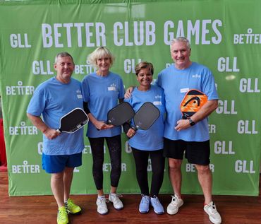 Group of pickleball players holding their paddles.