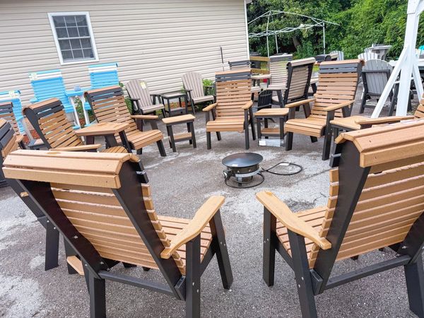 Outdoor seating area with wooden chairs arranged in a circle.