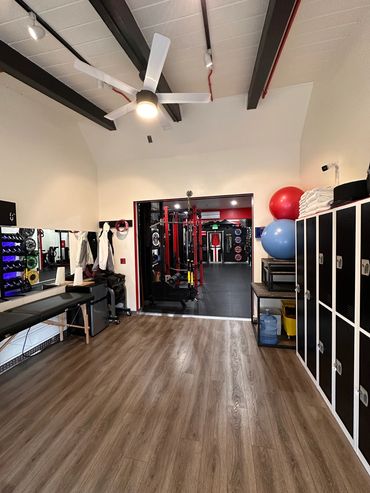Spacious fitness room with lockers and workout equipment.