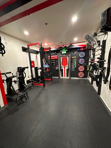 Empty gym room with fitness equipment and weights.