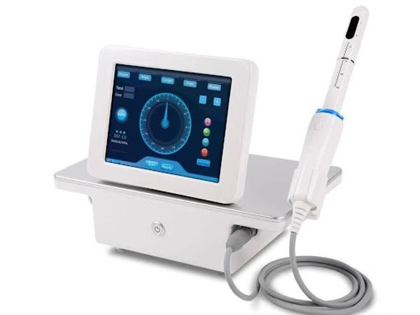 A modern dental or medical device with a touchscreen and handheld probe.