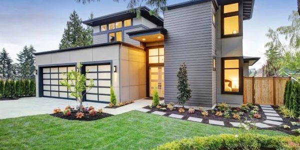 Modern two-story house with manicured lawn.