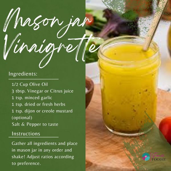 Mason jar filled with vibrant yellow vinaigrette on a wooden surface.
