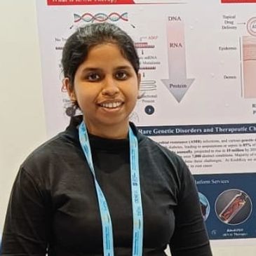 Woman smiling at a science event.
