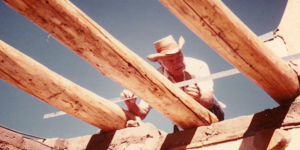 H.L. Mason leveling beams while building his Taos, NM artist's studio (1983)