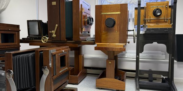 A collection of vintage wooden cameras displayed indoors.