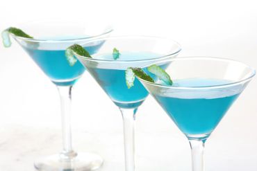Three Blue Martinis With Lime Peel