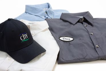 Work shirts and hat with logo on table. - Product Photography by S&C Design Studios