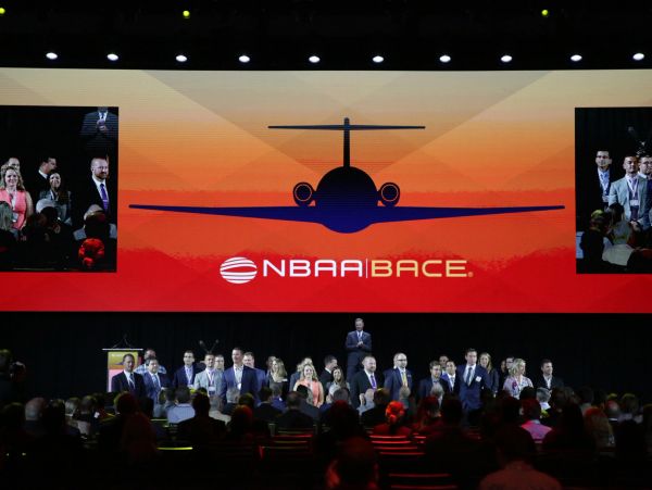 Conference presentation with NBAA|BACE logo on screen.