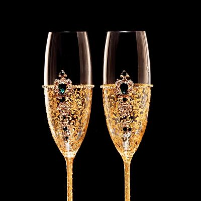 Elegant pair of gold-embellished champagne flutes with intricate gemstone designs.