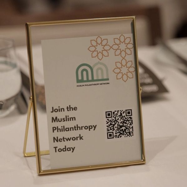 Sign inviting to join the Muslim Philanthropy Network with QR code.