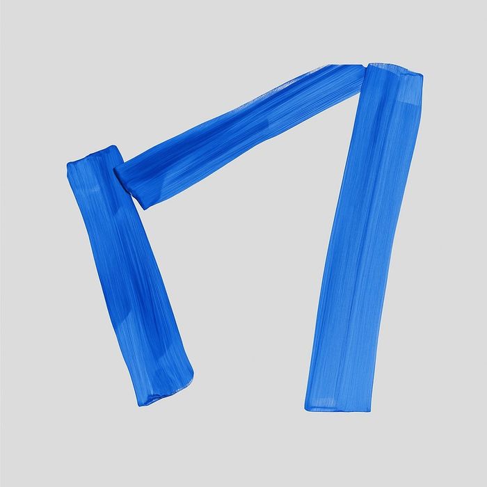 Abstract blue brush strokes forming an angular shape on a gray background.