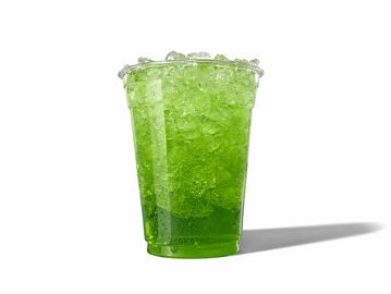 A clear plastic cup filled with green crushed ice against a white background.