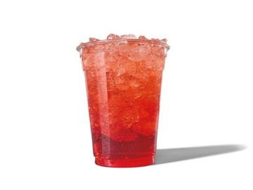 A clear plastic cup filled with red iced beverage casting a shadow.