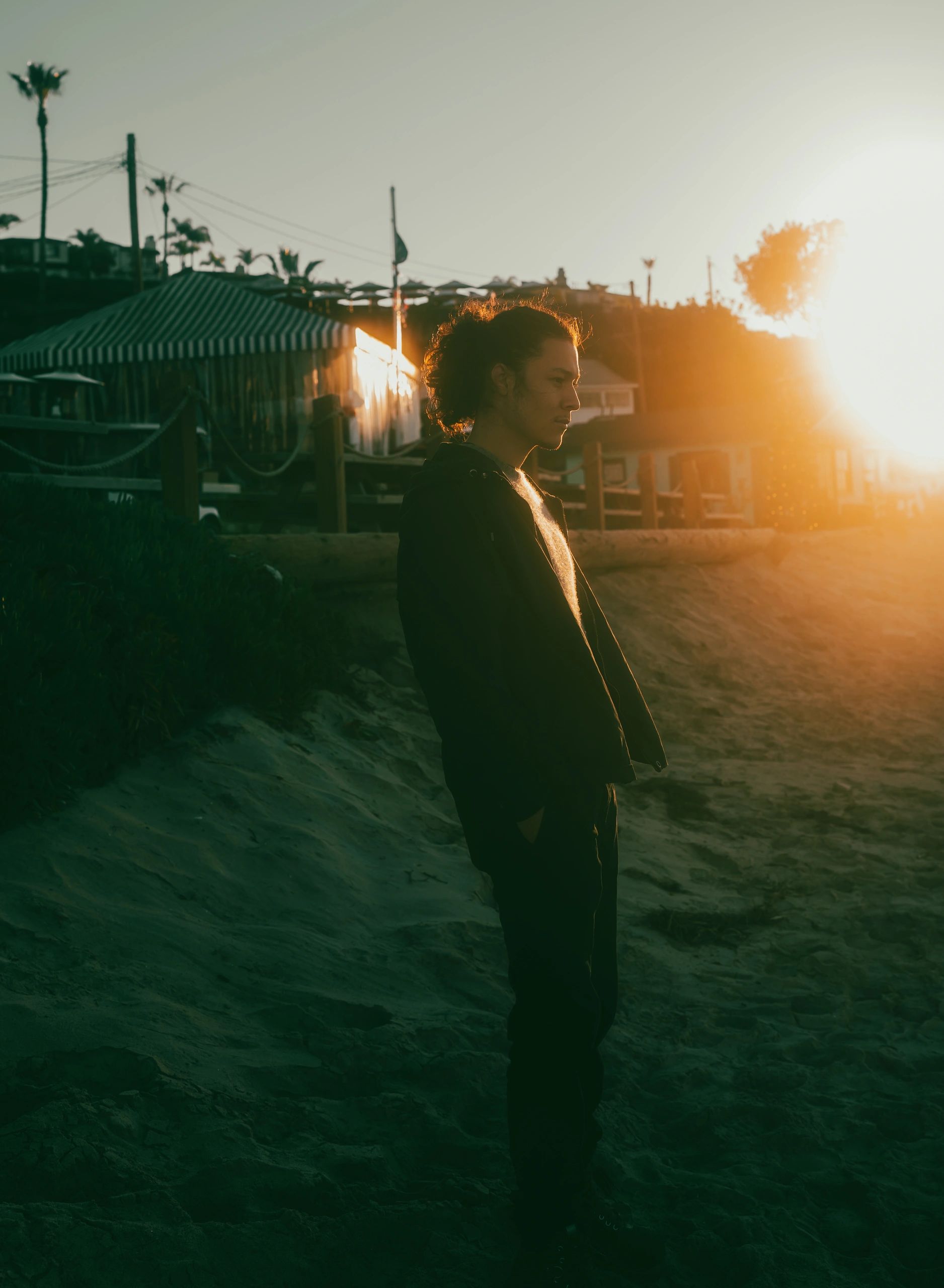 Early morning sunrise photo of male model on beach