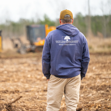 West Dale the owner, overseeing the land clearing, mulching, grading, and landscaping efforts.