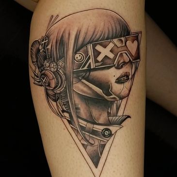 Cyberpunk-style tattoo of a woman with futuristic glasses and headset on a thigh.