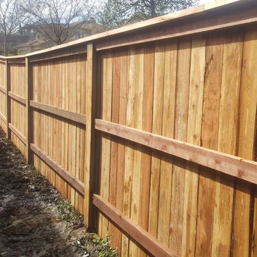 Redwood Top Cap Fence with pressure-treated 2x4 rails in El Dorado Hills, CA.