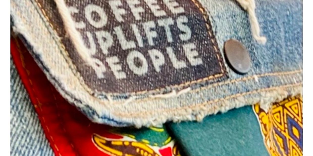 Denim patch with uplifting text on colorful fabric.