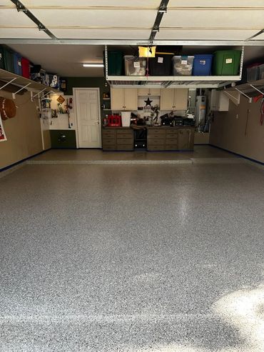 Garage concrete floor resurfaced with PolyChip flake system for garage floors.