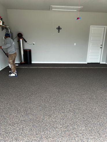 Garage concrete floor resurfaced with PolyChip flake system for garage floors.