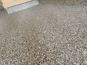 Garage concrete floor resurfaced with PolyChip flake system for garage floors.