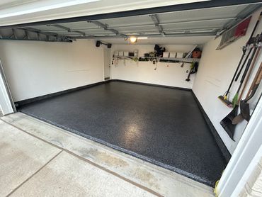 Garage concrete floor resurfaced with PolyChip flake system for garage floors.