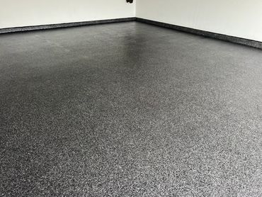 Garage concrete floor resurfacing with PolyChip flake system for garage coatings.
