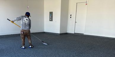 Application of Polyaspartic top coat on garage floor. Superior to epoxy garage floor systems.