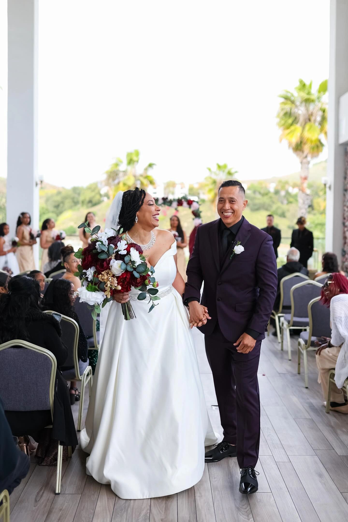 Joyful bride and groom walking hand in hand after their wedding ceremony.